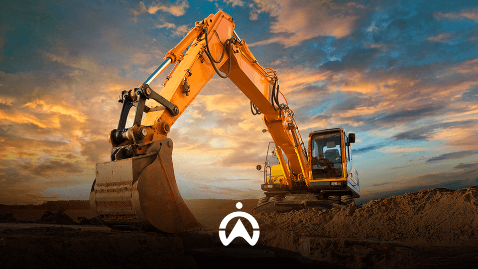A yellow excavator stands in a construction site under a dramatic sunset sky, with its bucket poised over a pile of earth.