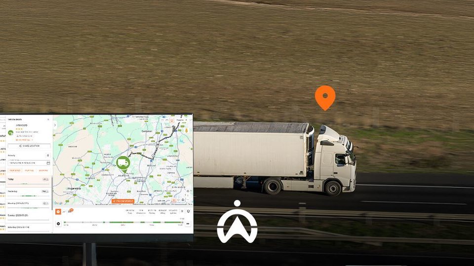 A white truck drives along a highway while a map on a monitor shows its location with an orange pin.