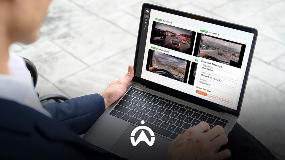 A person interacts with a laptop displaying multiple camera feeds and a request form for video footage.