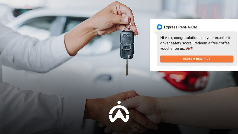 A person hands over car keys while the screen displays a message congratulating Alex on his driver safety score and offers a coffee voucher.